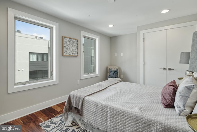 bedroom featuring dark hardwood / wood-style flooring and a closet