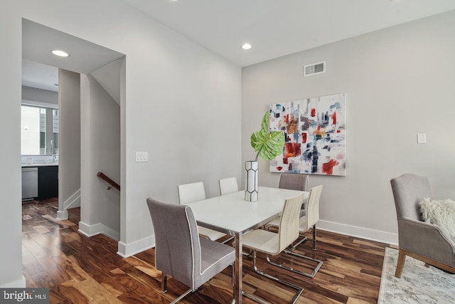 dining space with dark hardwood / wood-style floors