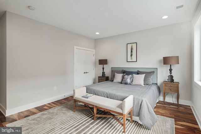 bedroom with dark wood-type flooring