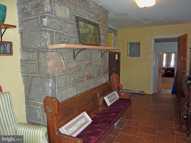 hallway with dark tile flooring