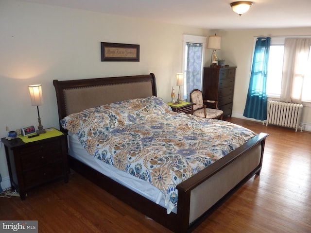 bedroom featuring radiator and dark wood-type flooring