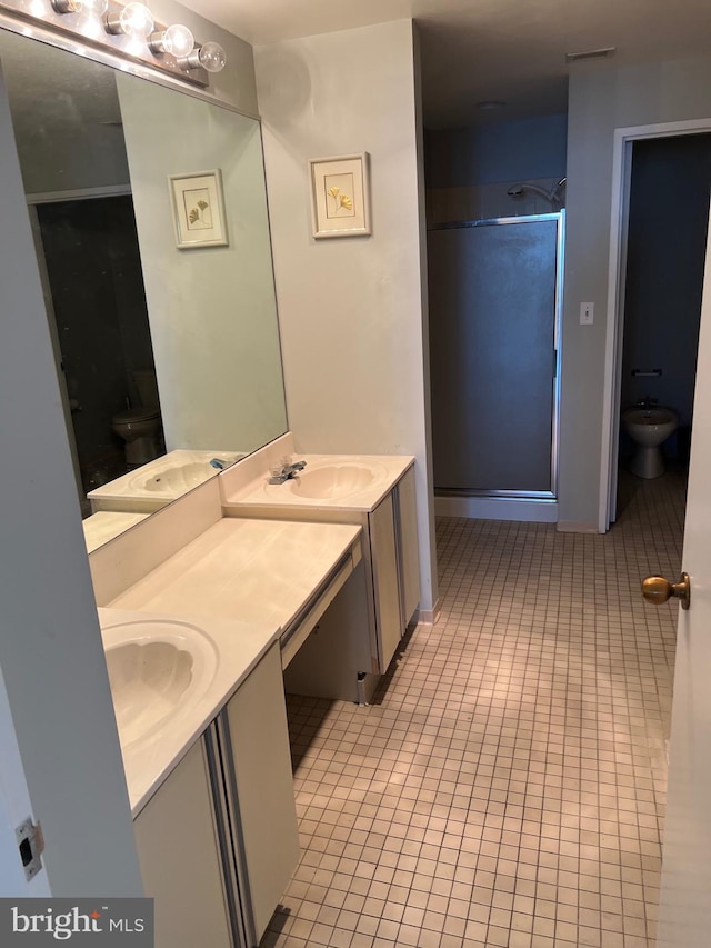 bathroom with tile patterned flooring, a shower with door, vanity, and toilet