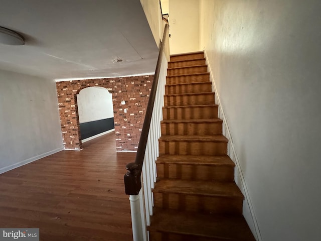 staircase featuring dark hardwood / wood-style floors