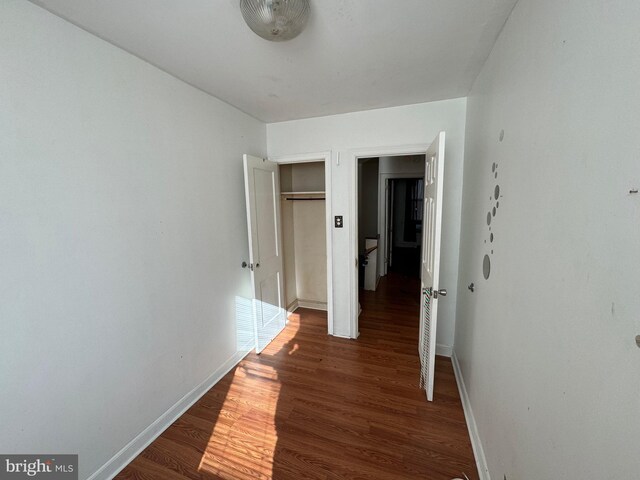 hall with dark wood-type flooring