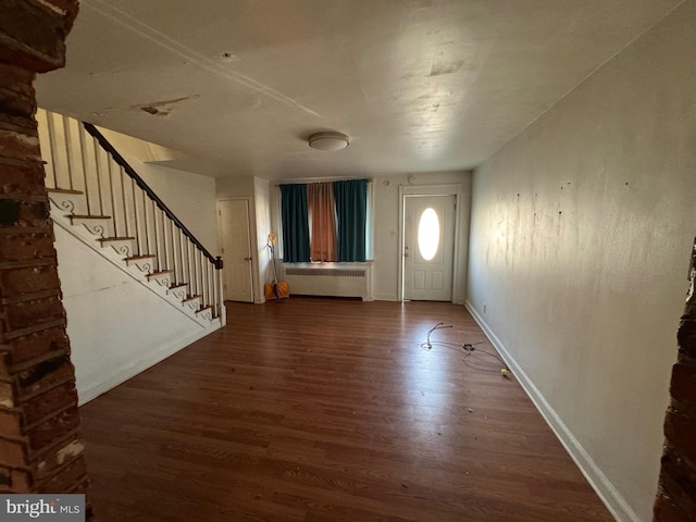 entrance foyer with dark hardwood / wood-style flooring and radiator