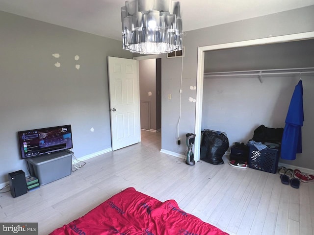 bedroom with hardwood / wood-style flooring and a closet