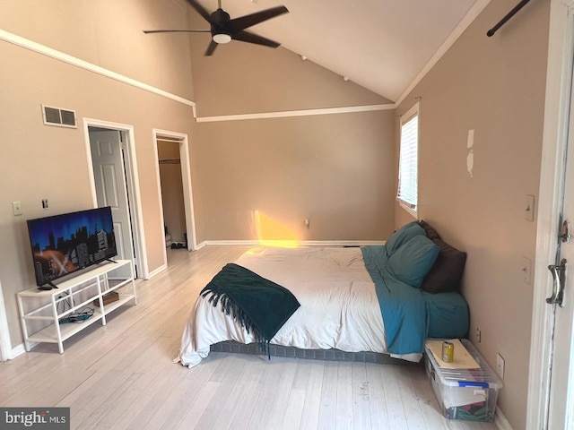 bedroom featuring ceiling fan, crown molding, high vaulted ceiling, and hardwood / wood-style flooring