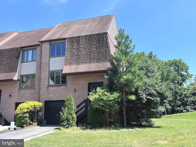 view of side of home with a garage and a lawn