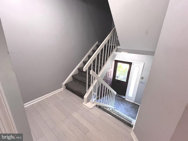 stairway with hardwood / wood-style flooring