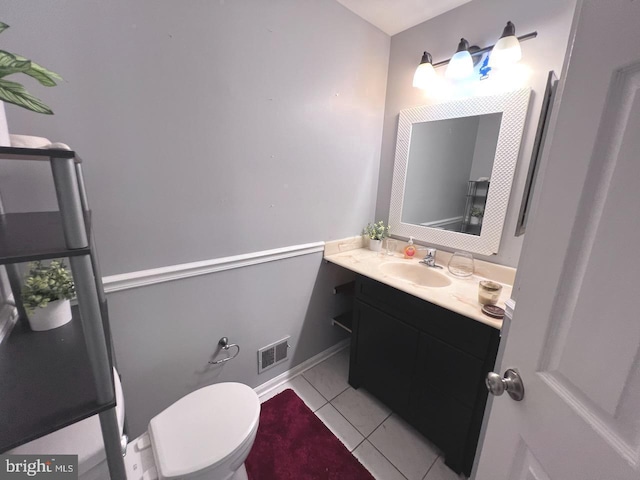 bathroom featuring tile patterned floors, vanity, and toilet