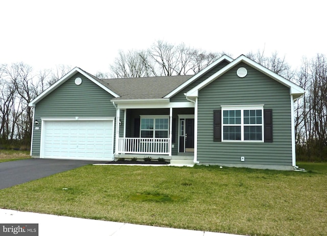 ranch-style home featuring a porch, a front lawn, and a garage