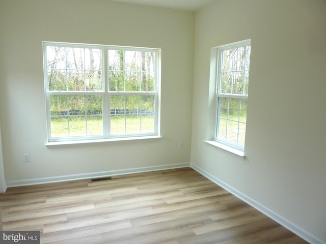 spare room with light hardwood / wood-style flooring