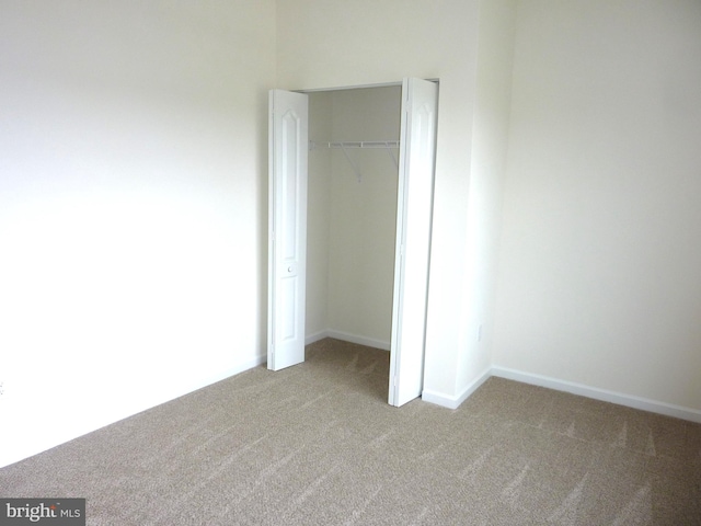 unfurnished bedroom with carpet and a closet