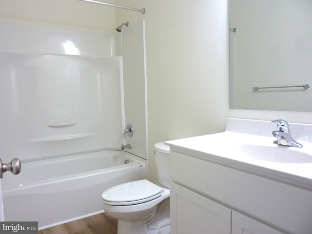 full bathroom featuring shower / washtub combination, toilet, hardwood / wood-style floors, and vanity