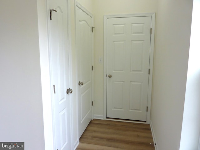 hallway featuring dark hardwood / wood-style flooring