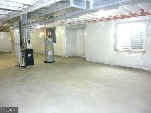 basement featuring water heater and heating utilities