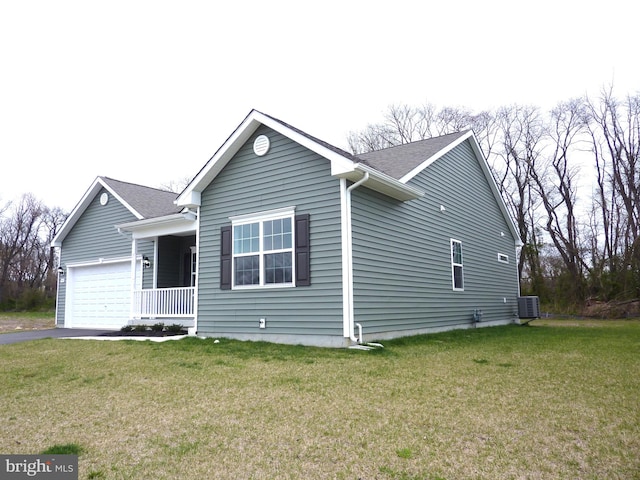 view of front facade with central AC unit, a front lawn, and a garage