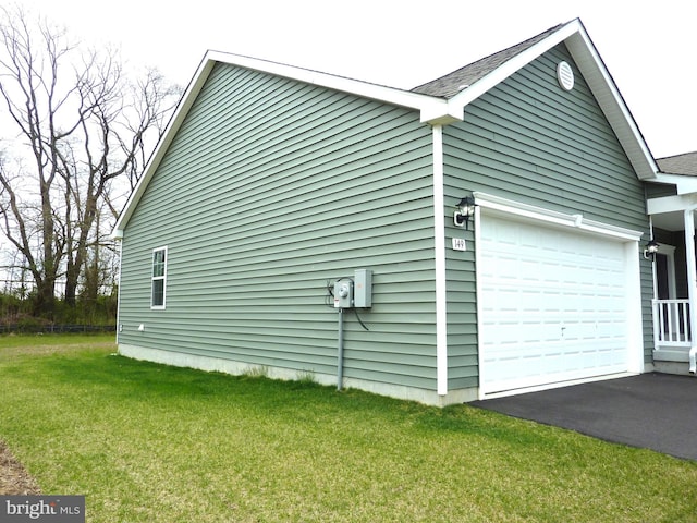 view of property exterior featuring a lawn and a garage