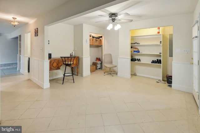 interior space featuring built in features, ceiling fan, and light tile floors