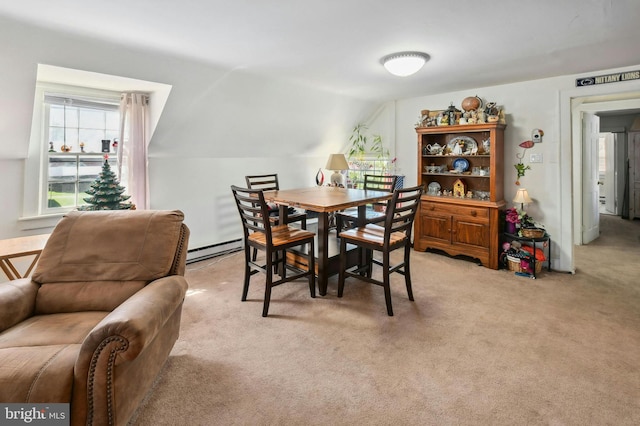 carpeted dining area with vaulted ceiling and baseboard heating