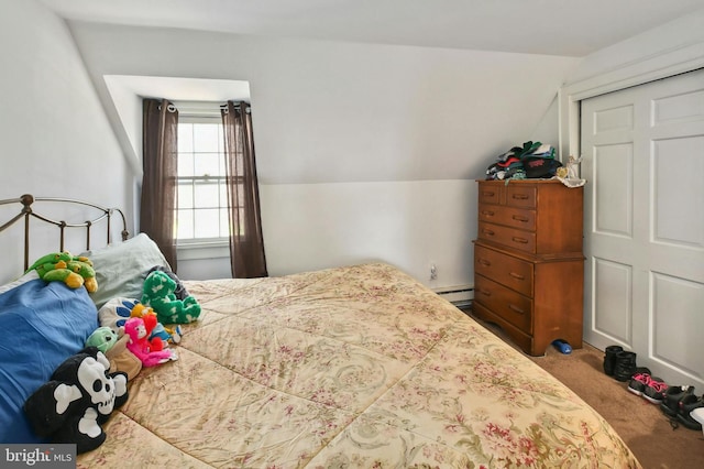 carpeted bedroom featuring a closet, lofted ceiling, and baseboard heating