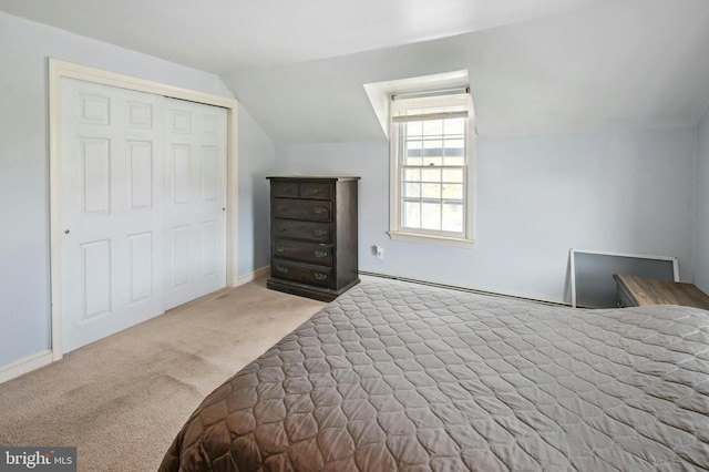 bedroom featuring vaulted ceiling, carpet flooring, and a closet