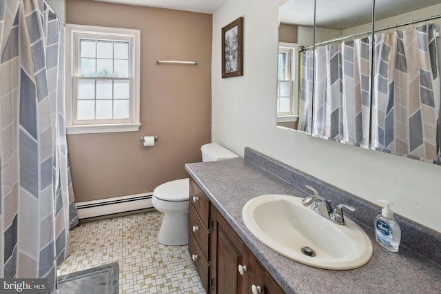 bathroom featuring tile floors, vanity with extensive cabinet space, toilet, and baseboard heating