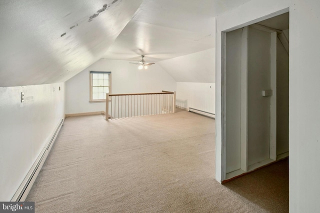 bonus room featuring carpet flooring, ceiling fan, a baseboard radiator, and lofted ceiling