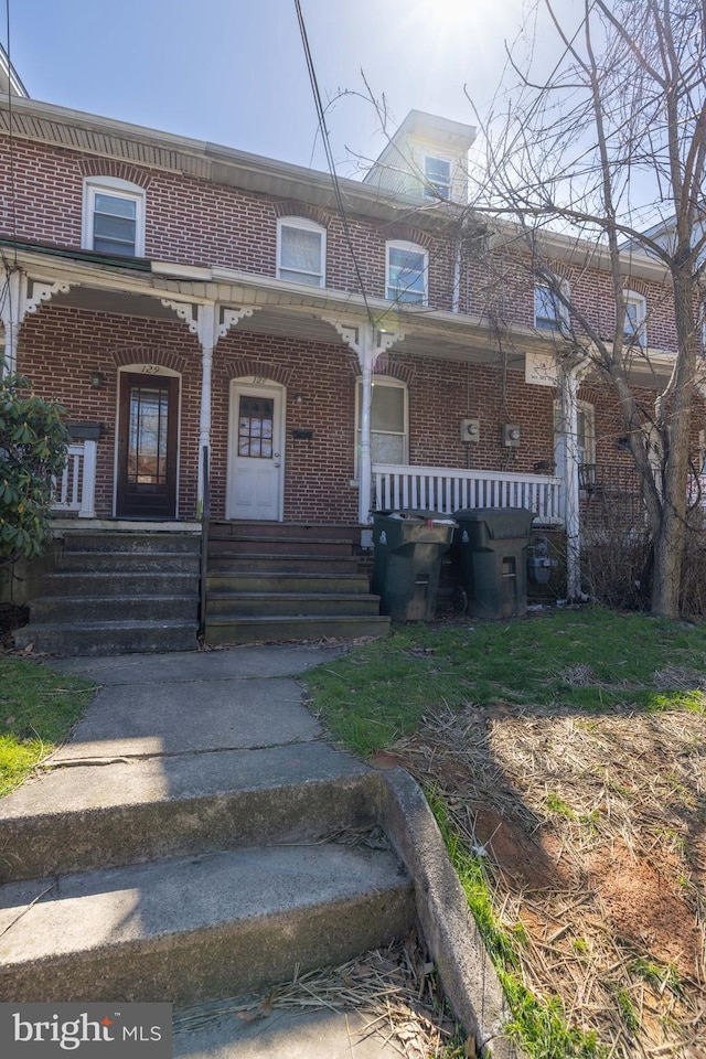 view of property featuring covered porch