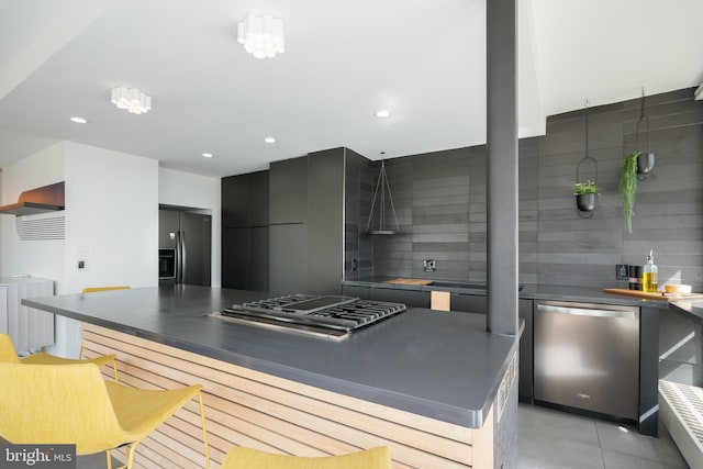 kitchen featuring stainless steel appliances, tasteful backsplash, and light tile flooring