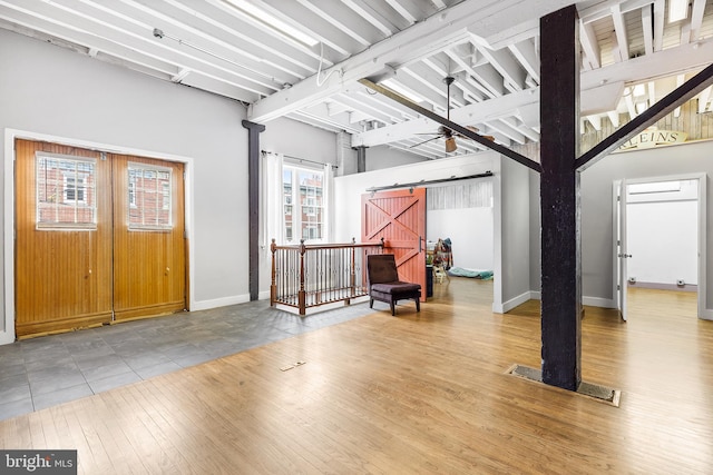 entryway featuring a barn door and light tile flooring