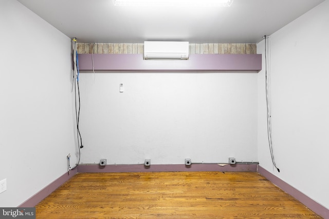 interior space featuring hardwood / wood-style flooring and a wall mounted AC