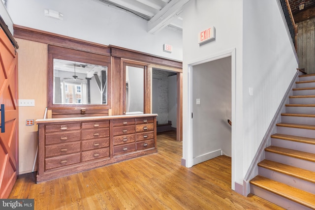 interior space with beamed ceiling and light wood-type flooring