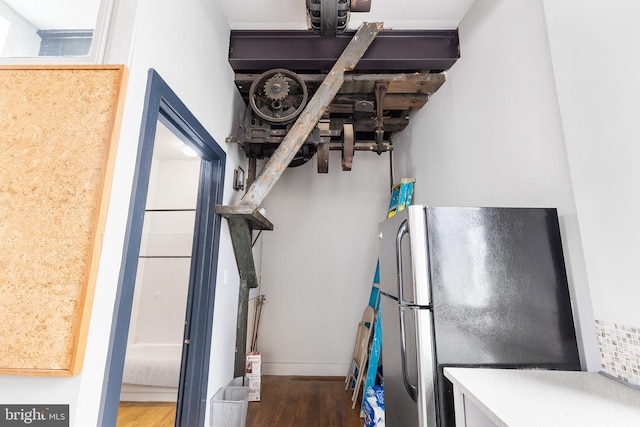 interior space featuring dark hardwood / wood-style flooring and stainless steel fridge