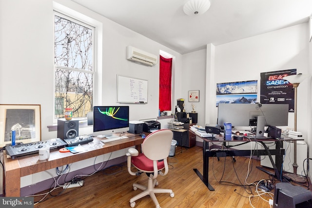 office area featuring a wealth of natural light, light hardwood / wood-style floors, and a wall mounted AC