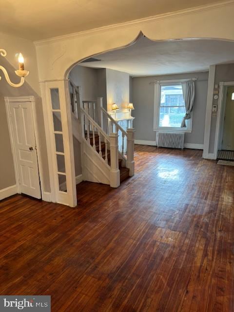 empty room with radiator and dark hardwood / wood-style flooring