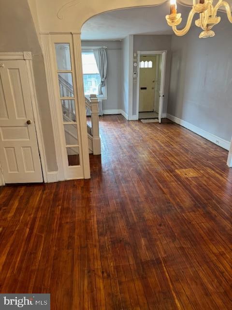 entrance foyer featuring dark hardwood / wood-style floors and a chandelier