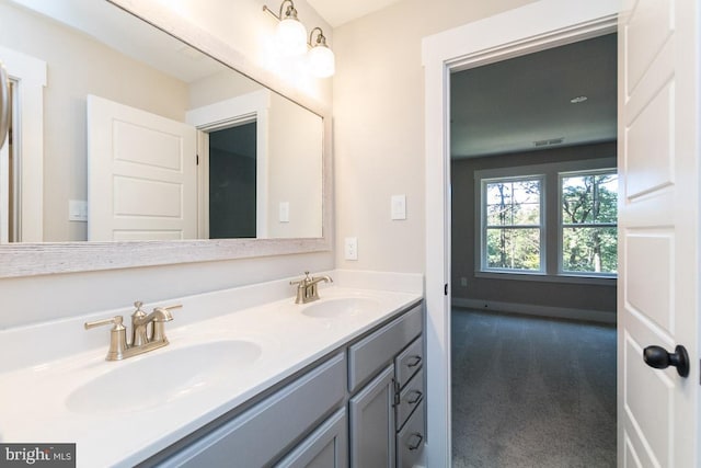 bathroom with vanity with extensive cabinet space and double sink