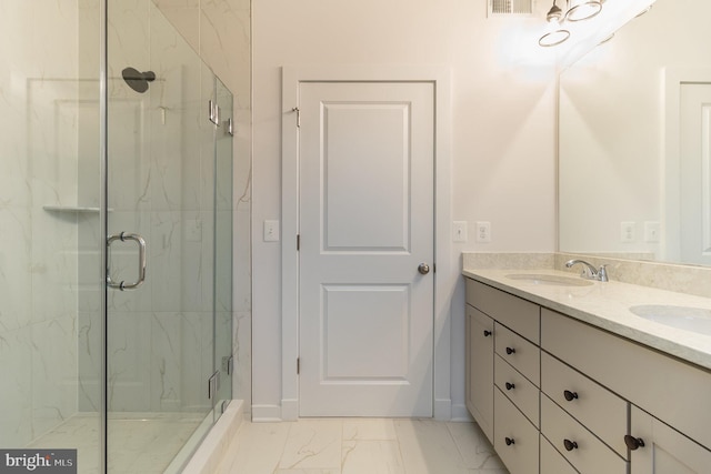 bathroom with dual vanity, tile floors, and a shower with door