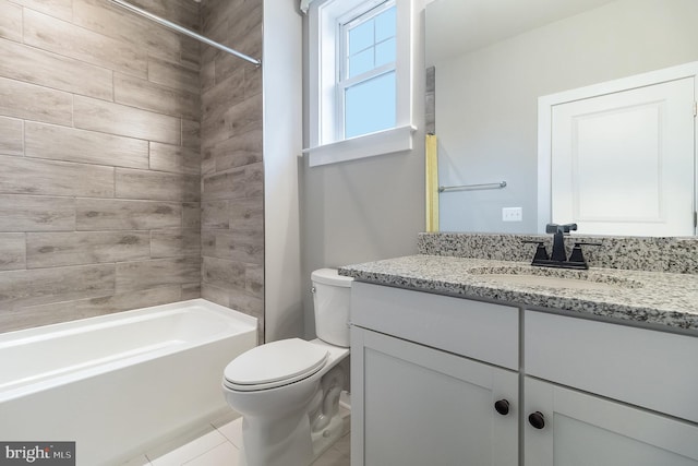 full bathroom featuring tile flooring, bathtub / shower combination, toilet, and vanity with extensive cabinet space