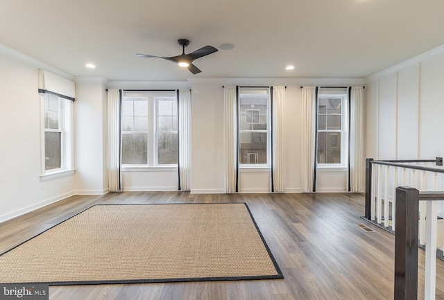 interior space featuring ceiling fan, light wood-type flooring, and ornamental molding