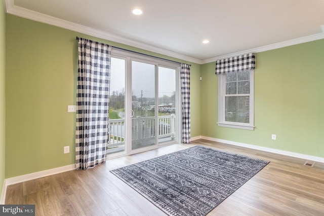 unfurnished room with crown molding and light hardwood / wood-style floors