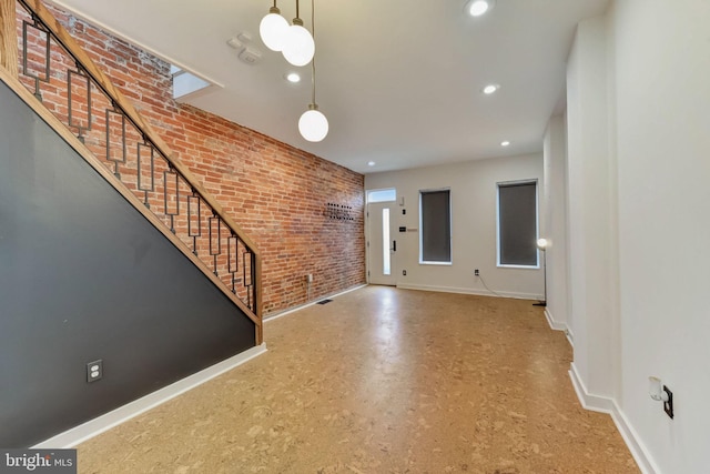 foyer entrance with brick wall