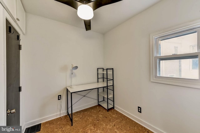 interior space featuring ceiling fan