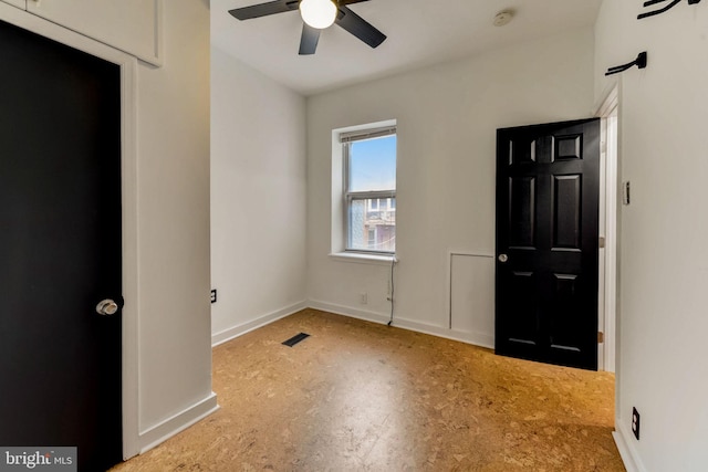 interior space featuring ceiling fan