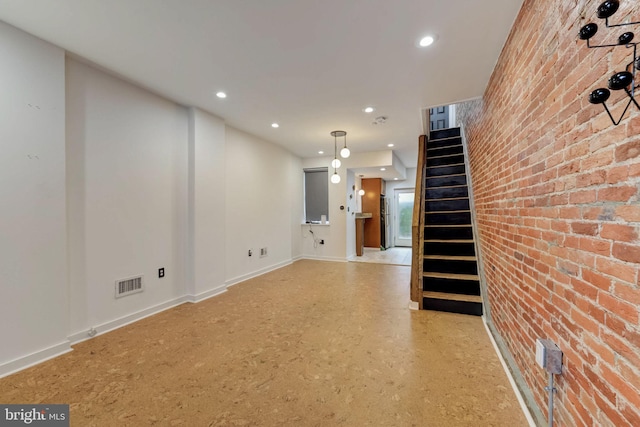 interior space featuring brick wall