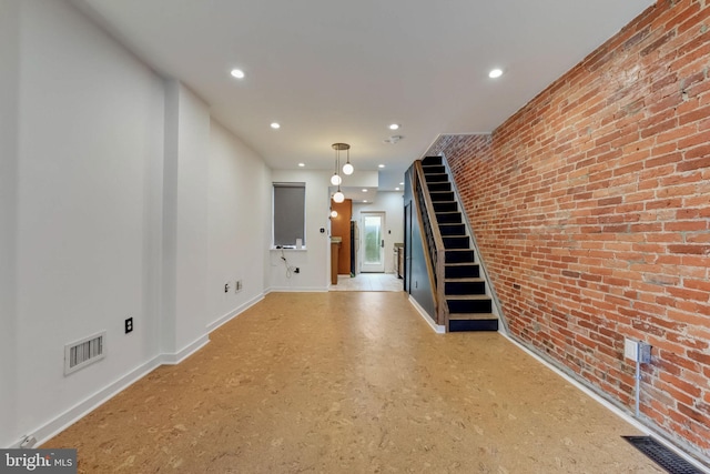 empty room featuring brick wall