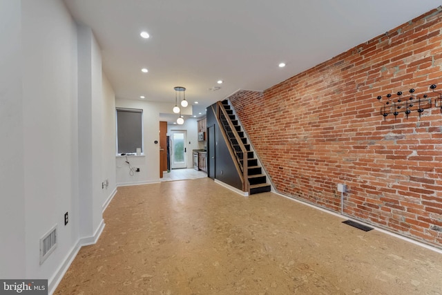 interior space featuring brick wall