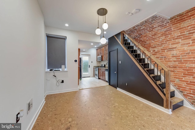 interior space featuring brick wall and a chandelier