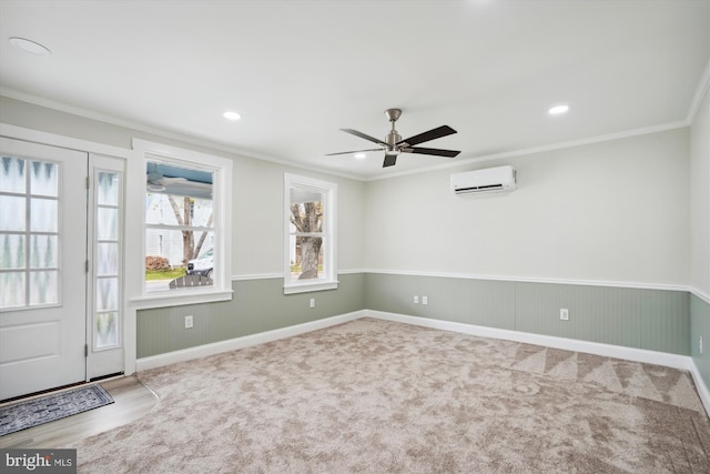 interior space featuring carpet flooring, a wall mounted AC, ornamental molding, and ceiling fan